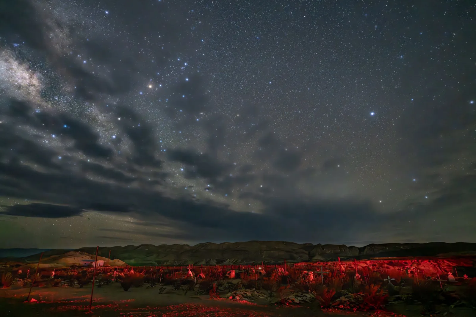Breathtaking starry night sky over Terlingua desert landscape with Milky Way and rugged terrain.
