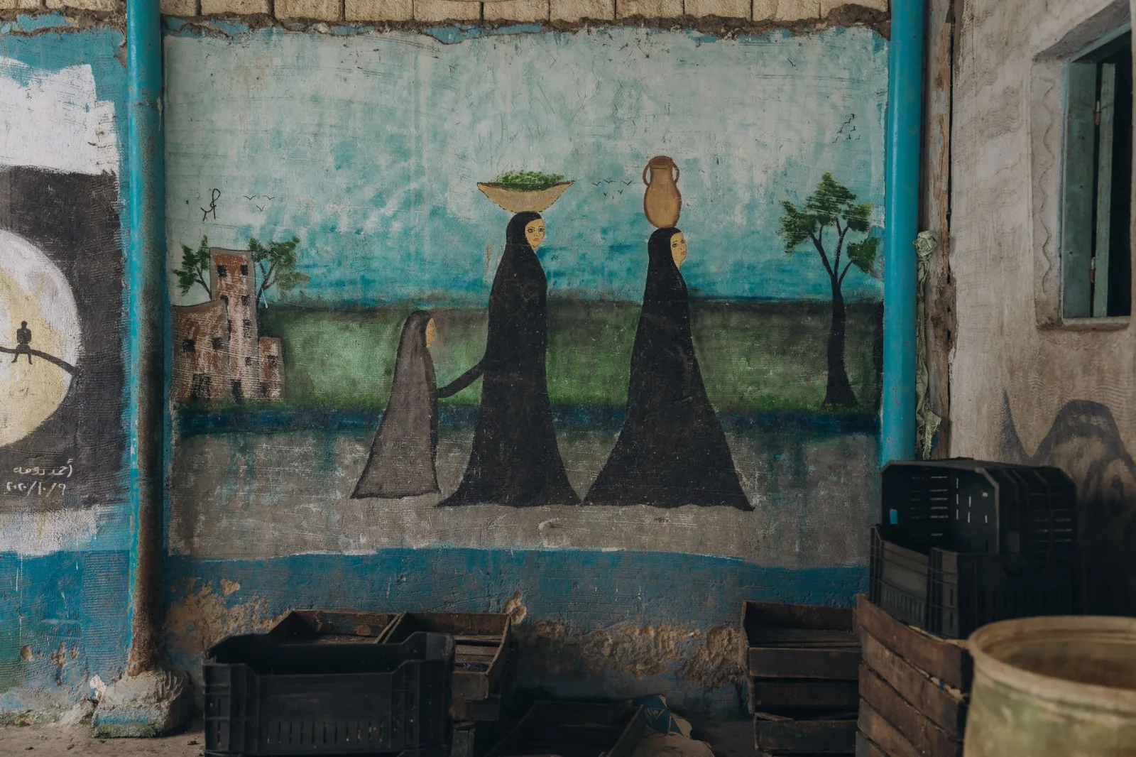 Mural showcasing traditional Egyptian women in Cairo, urban street art.