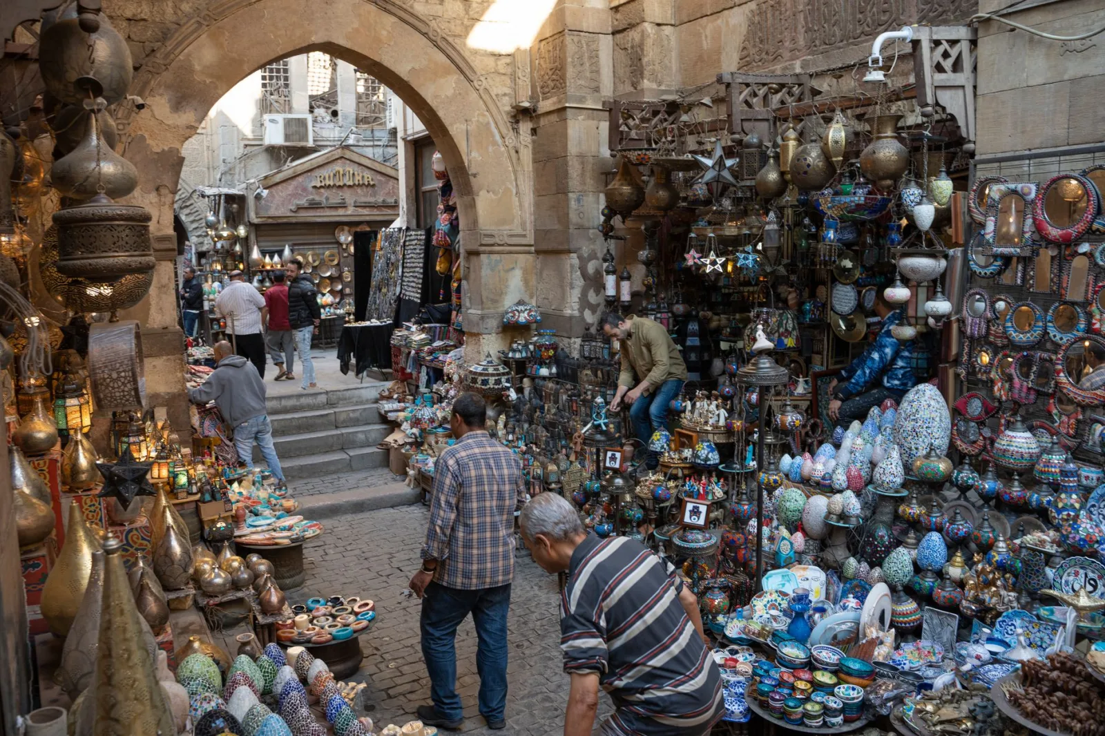 Vibrant street market with diverse Middle Eastern crafts and bustling activity.