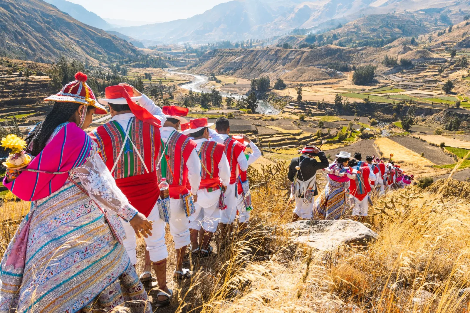 Vibrant Andean festival in Cayma, Peru with locals in traditional costumes celebrating cultural heritage.