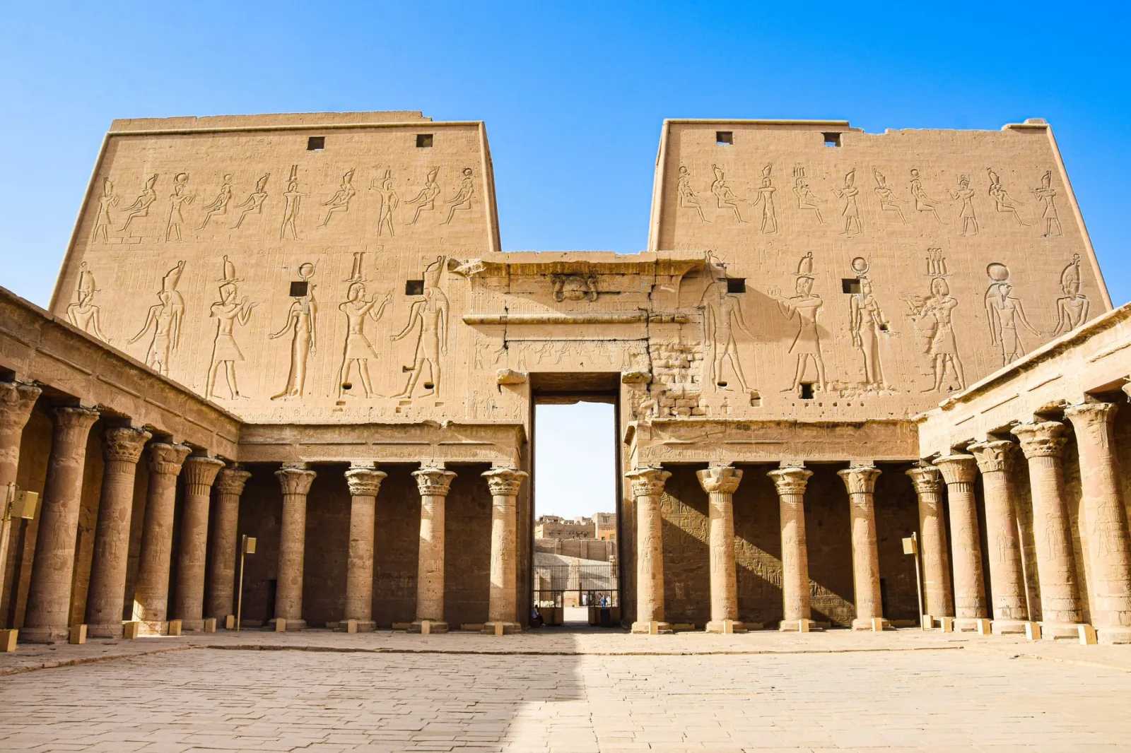 Explore the historic grandeur of ancient Egyptian ruins with towering columns and intricate carvings.