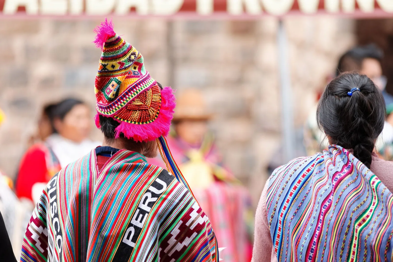 Colorful traditional clothing at a festival in Cusco, Peru, celebrating indigenous culture.