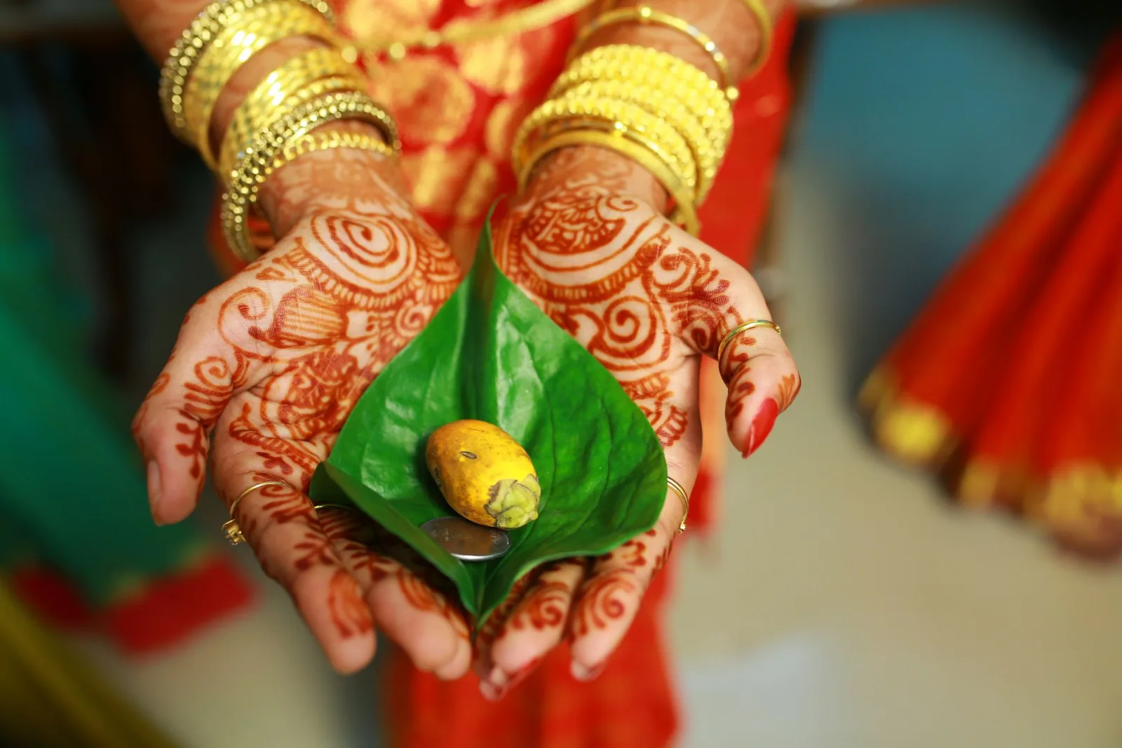 Intricate mehndi designs on hands during Indian wedding ritual, symbolizing tradition and culture.