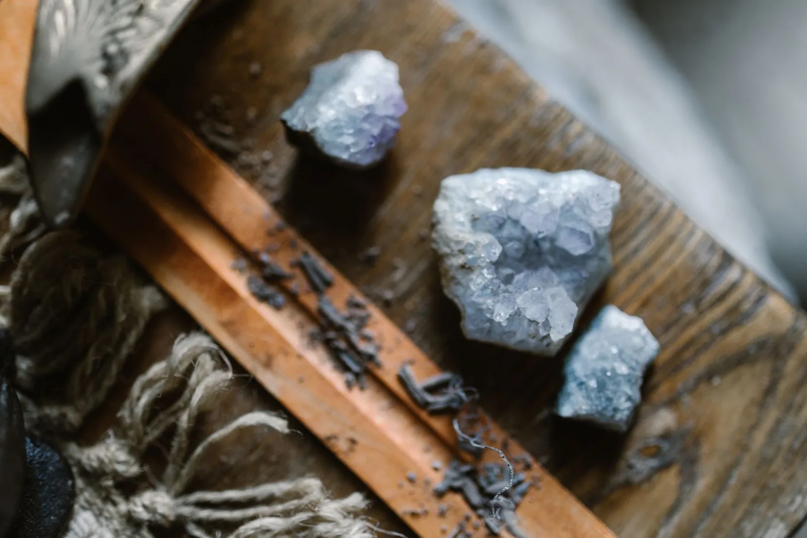 Artistic close-up of raw crystals on a textured wooden surface, creating a magical, rustic vibe.