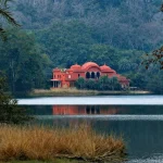 A picturesque hunting lodge by a tranquil lake in Ranthambore, Rajasthan, India.
