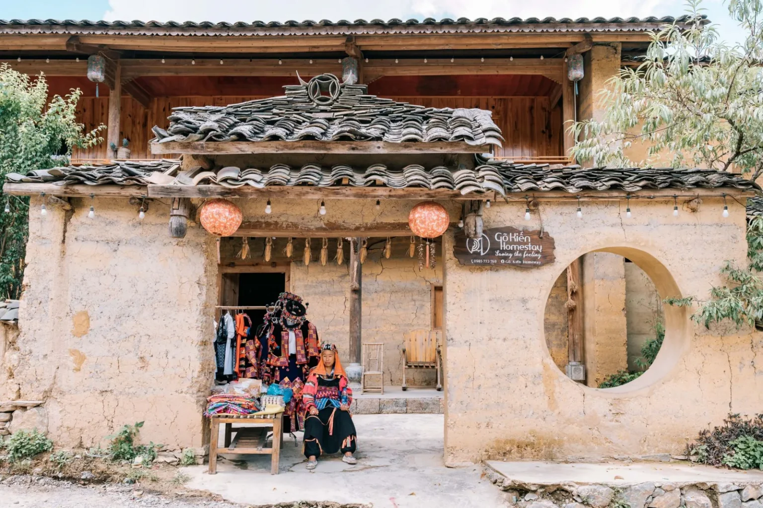 Traditional house in Lũng Cú, Vietnam showcasing cultural attire and decor.