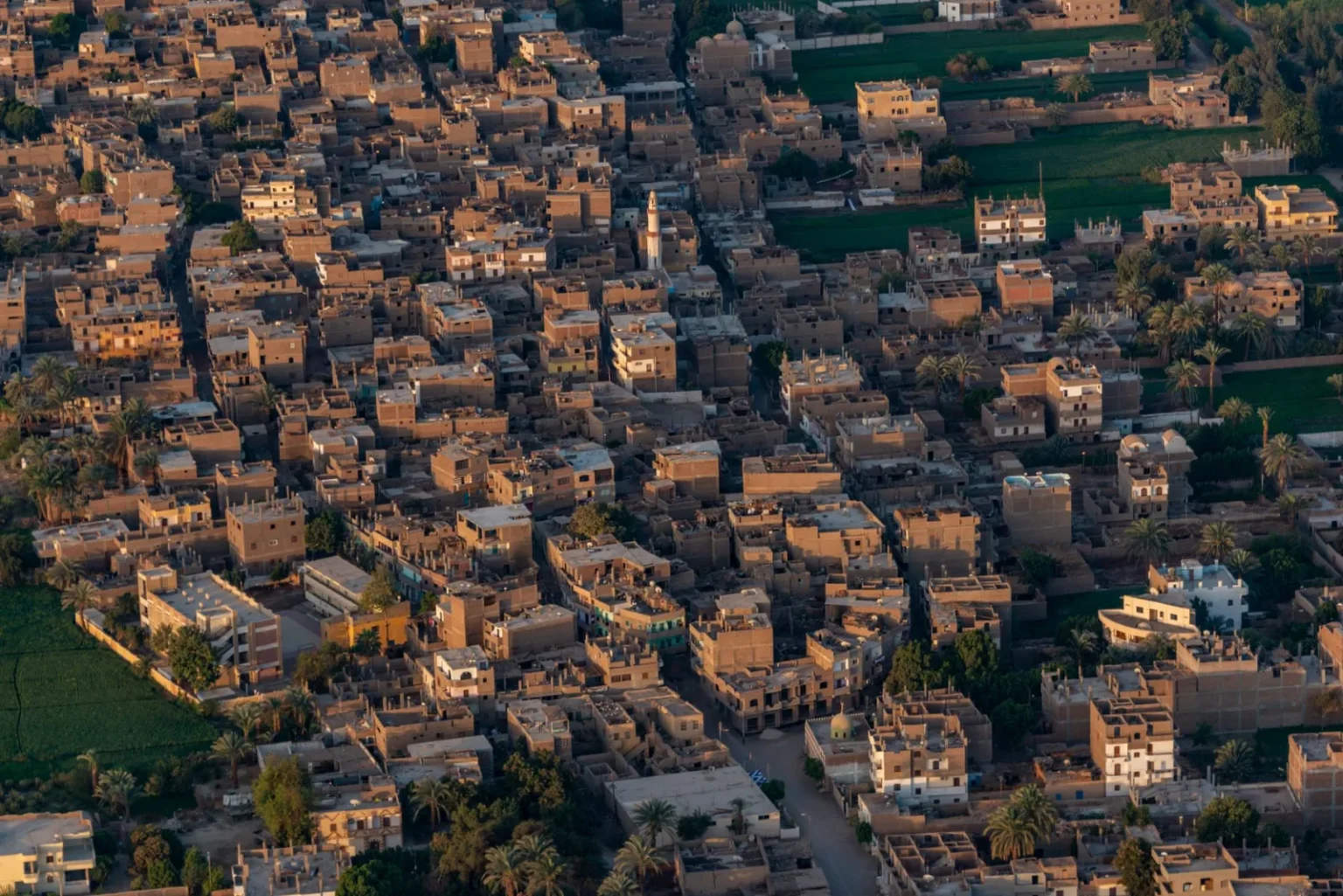 Aerial shot of a densely packed Middle Eastern town with traditional buildings.