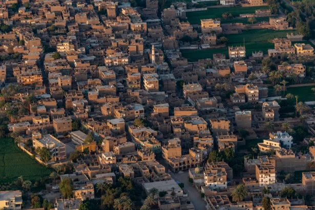 Aerial shot of a densely packed Middle Eastern town with traditional buildings.