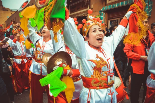 Joyous performers in traditional attire at Cairo's colorful drum festival celebration.