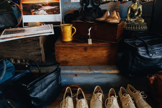 A charming display of vintage shoes, bags, and decor inside a rustic store setting.