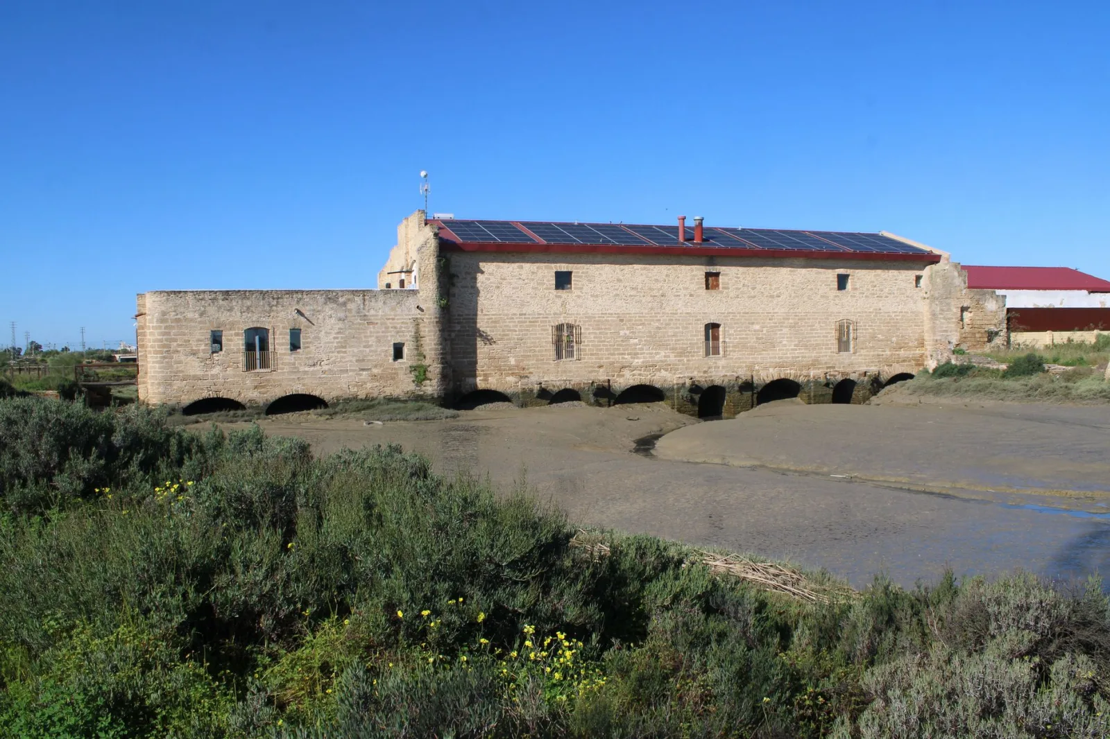 Historic tide mill in El Puerto de Santa María, preserved with solar panels on the roof.