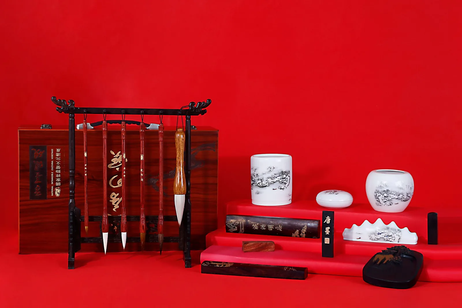 Elegant display of Chinese brush pens on a vibrant red background, showcasing cultural artistry.