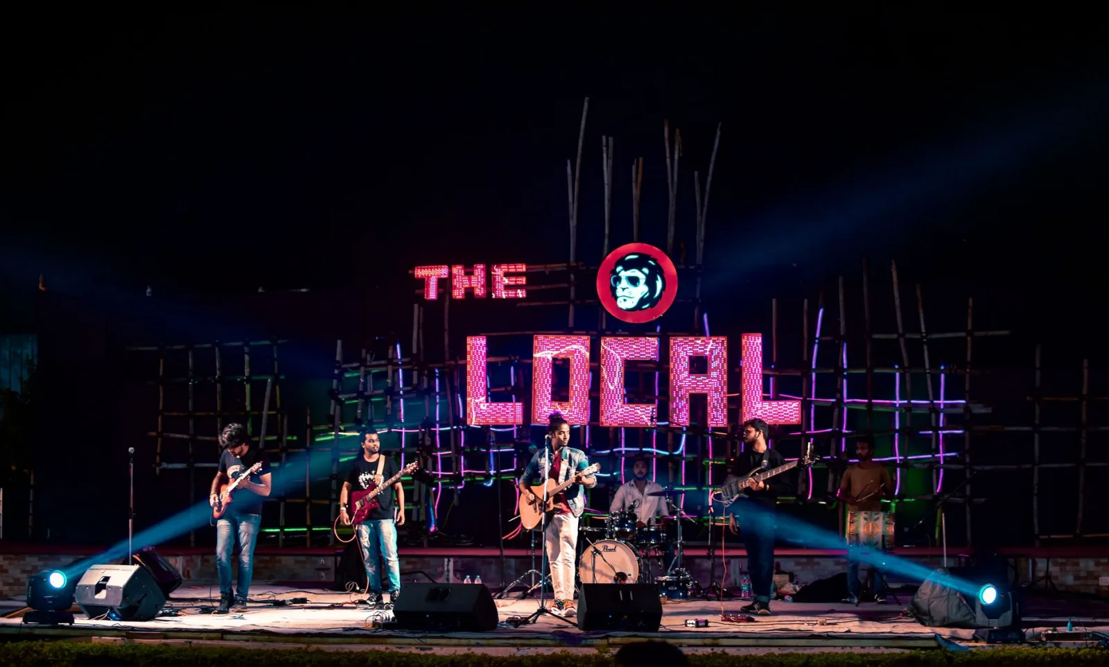 Energetic live music performance by a band on stage at The Local venue, Raipur.