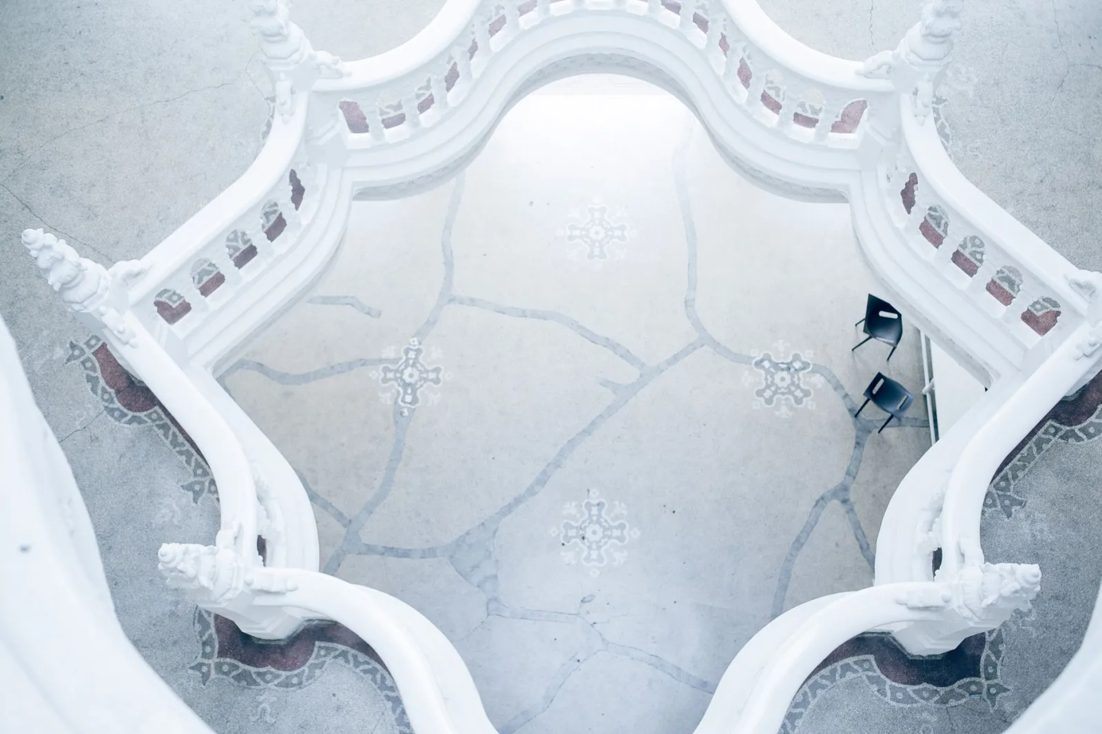 From above of elegant stone fence in center of classic multilevel structure with sculptures