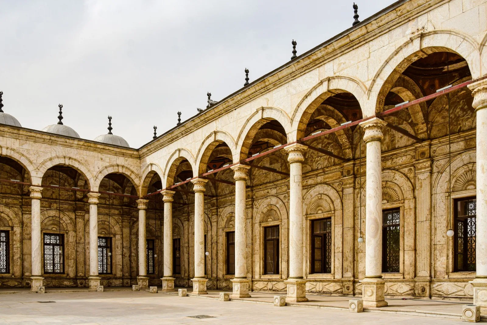Exploring the iconic arches and columns of the Citadel's alabaster mosque in Cairo's Islamic architecture.
