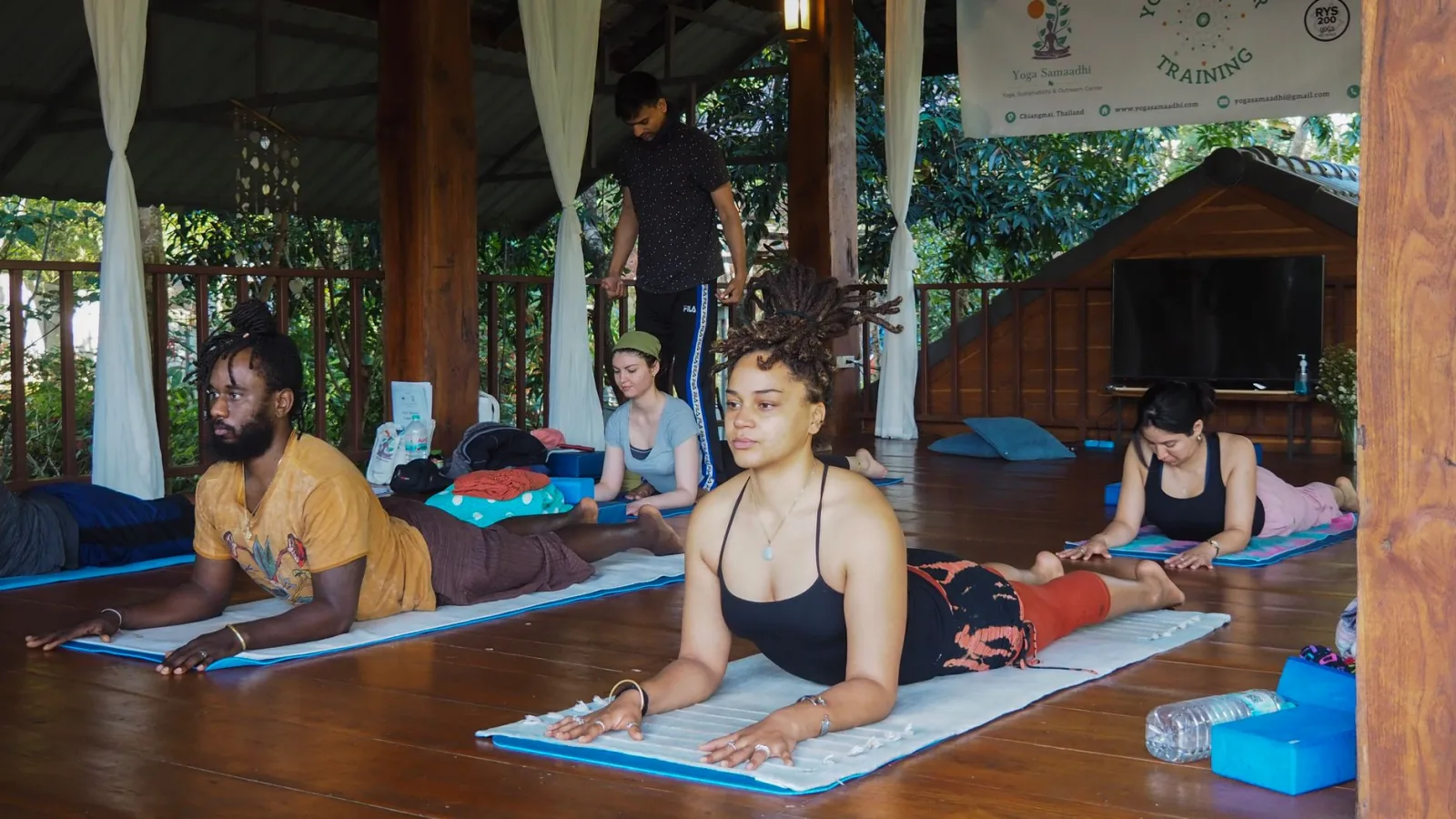 People practicing yoga together in a serene outdoor retreat