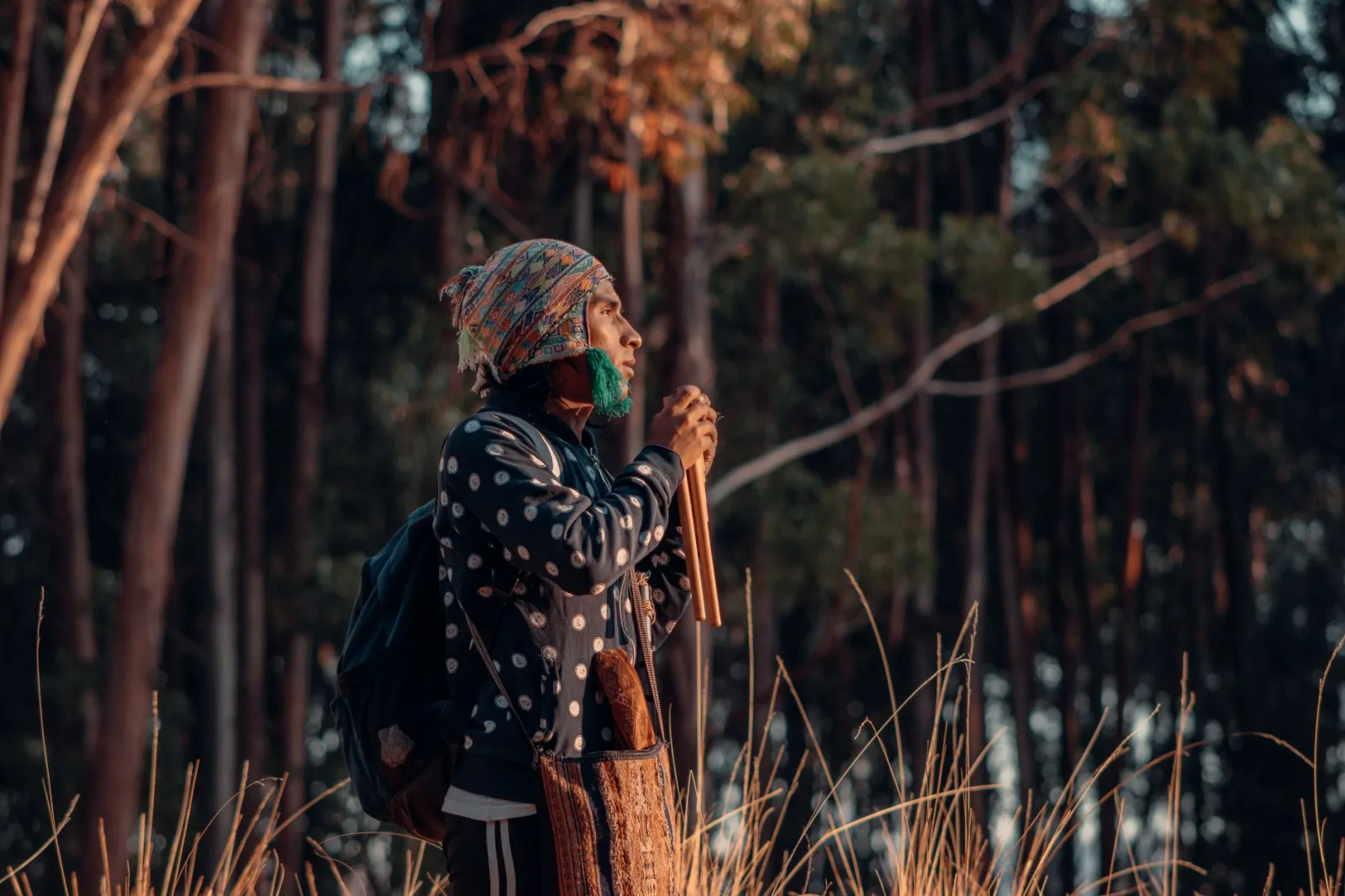 A musician passionately plays wooden pipes in a serene forest ambience.