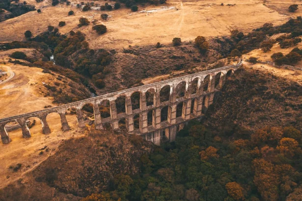 Aerial view of an ancient aqueduct in a picturesque Mexican landscape during autumn.