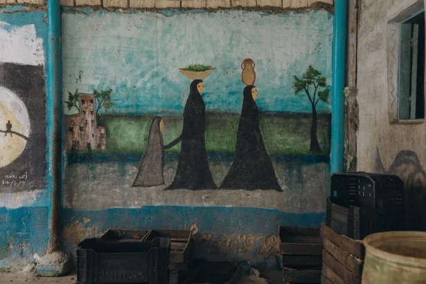 Mural showcasing traditional Egyptian women in Cairo, urban street art.