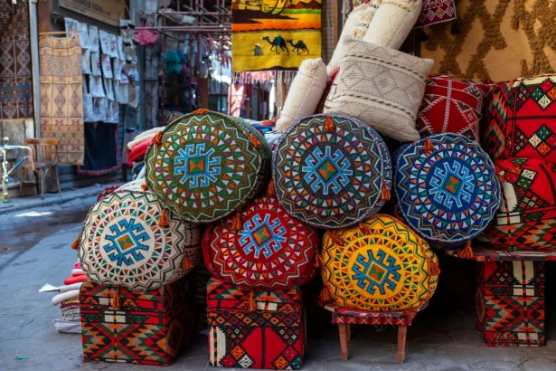 Vibrant handmade textiles and crafts at a Cairo market street.