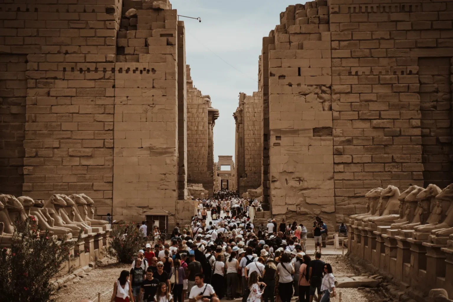 Massive crowd of tourists exploring the ancient Karnak Temple in Luxor, Egypt.