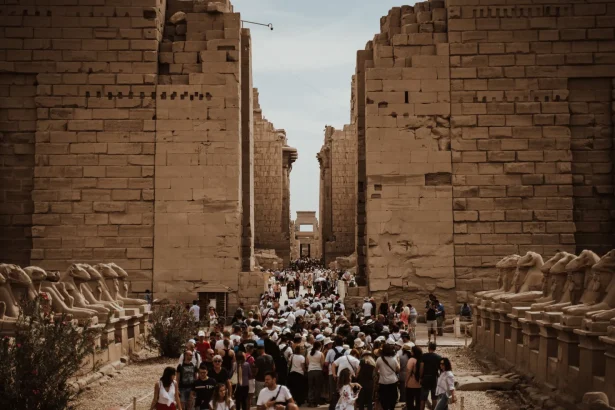 Massive crowd of tourists exploring the ancient Karnak Temple in Luxor, Egypt.