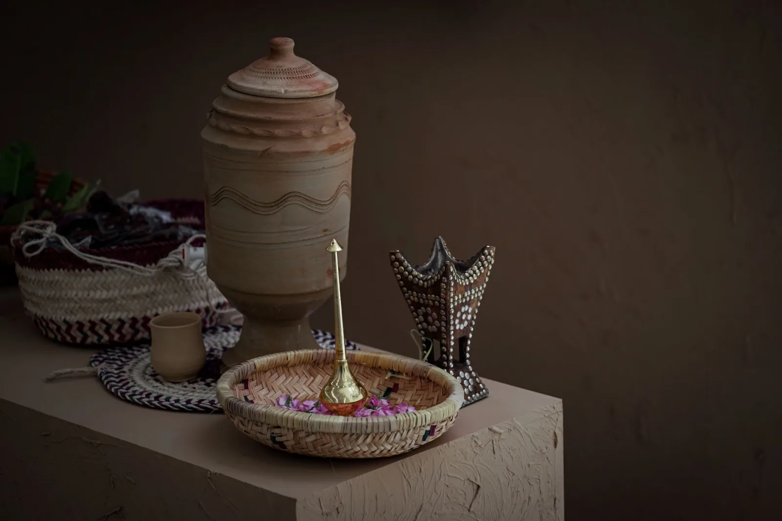A close-up of traditional Saudi Arabian handcrafted decor including baskets and pottery.