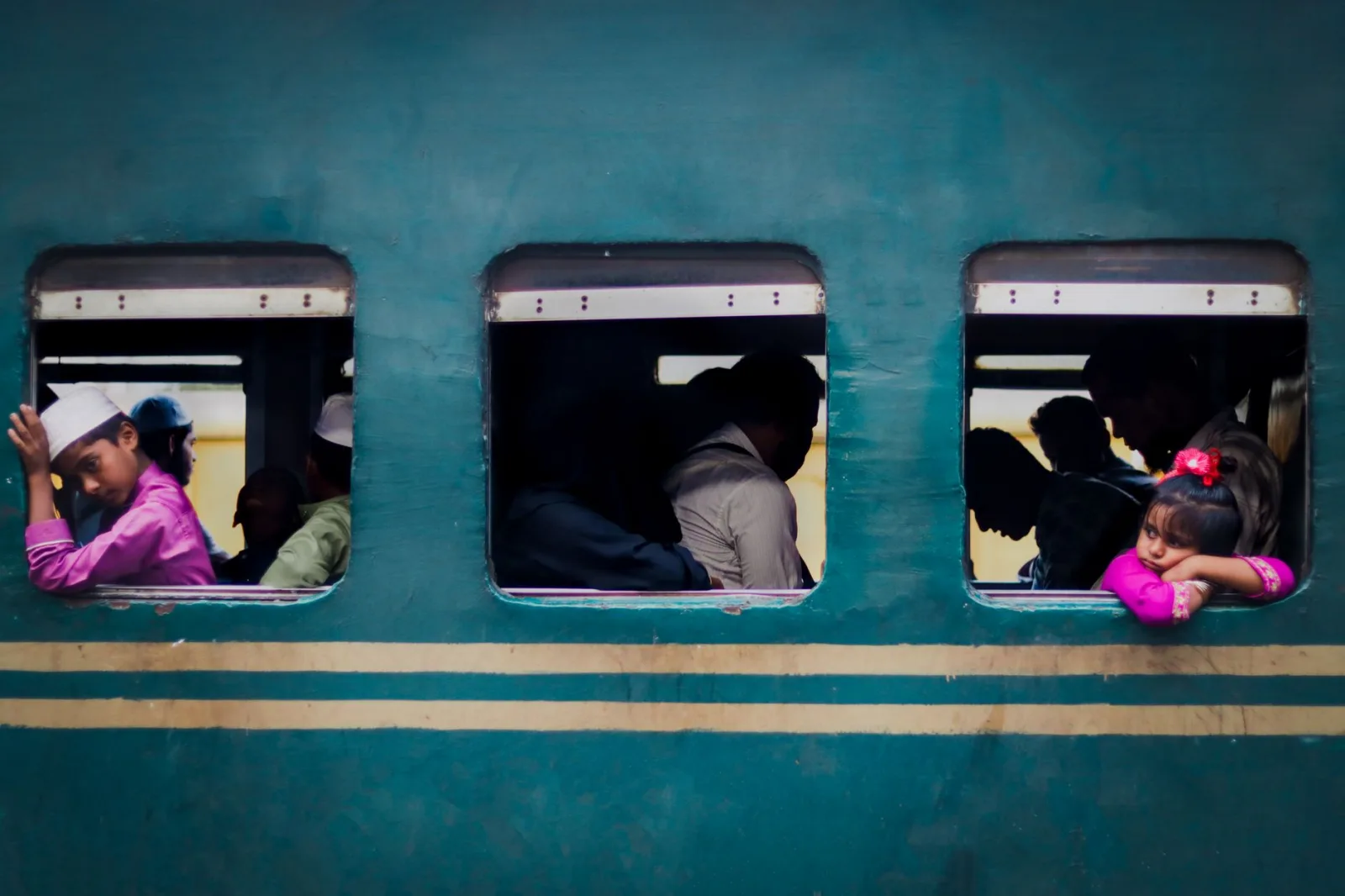 Captivating candid moment capturing daily train commute in Dhaka, Bangladesh, with vibrant colors and human connection.