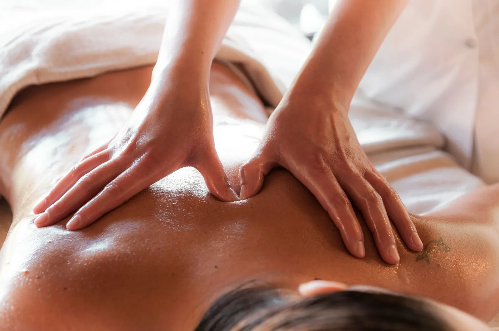 Close-up of a relaxing massage session, focusing on back therapy at a spa.