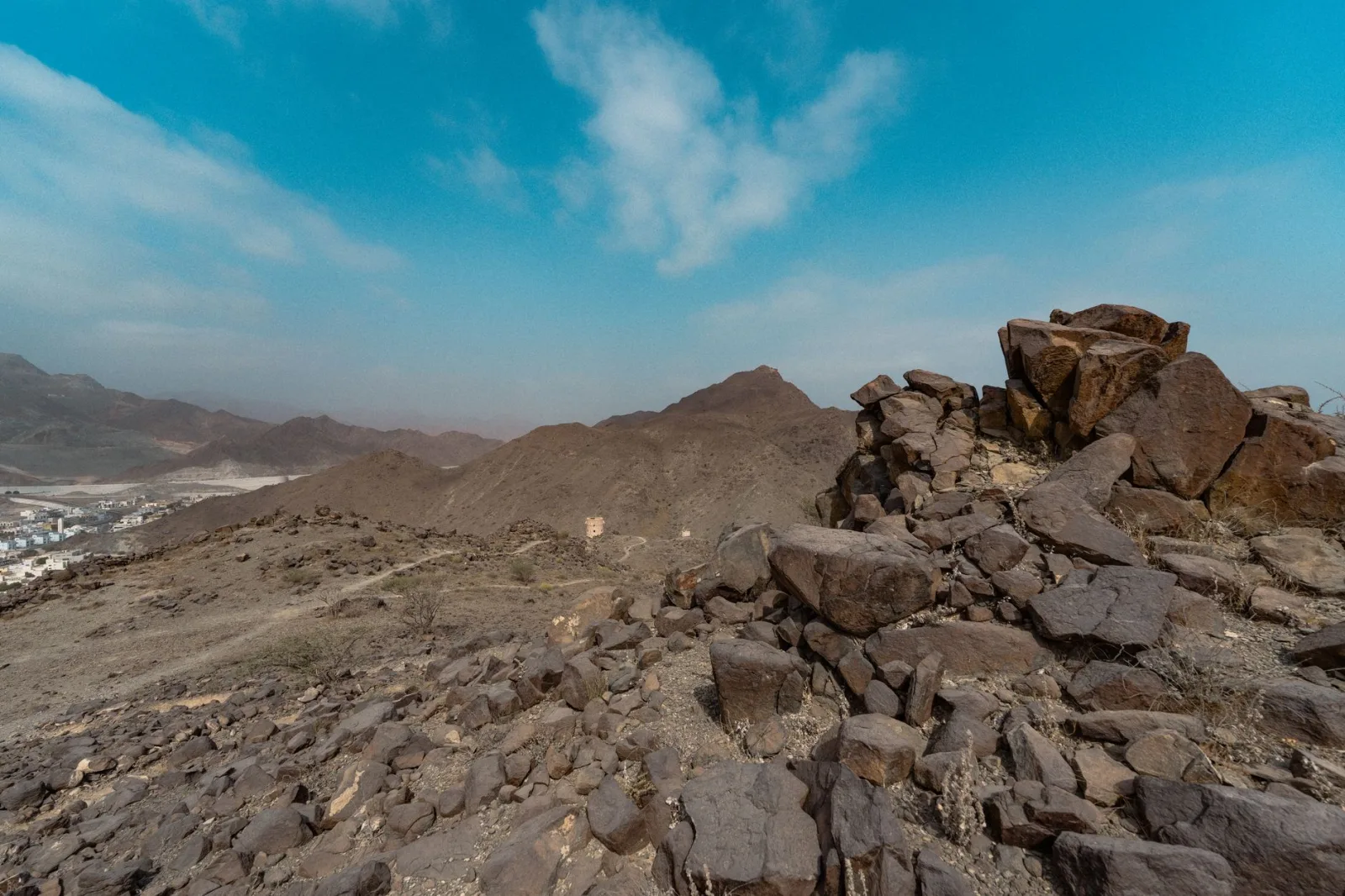 Explore the rugged landscape of Khor Fakkan, Sharjah with its dramatic rocky terrain and clear blue skies.