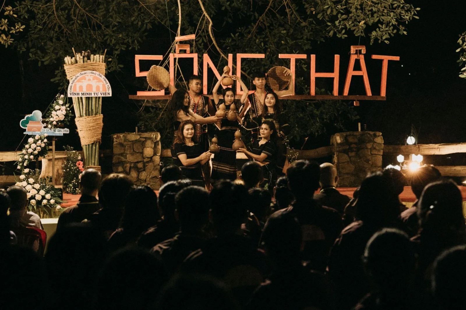 People gather for an evening cultural performance with traditional music and dance.