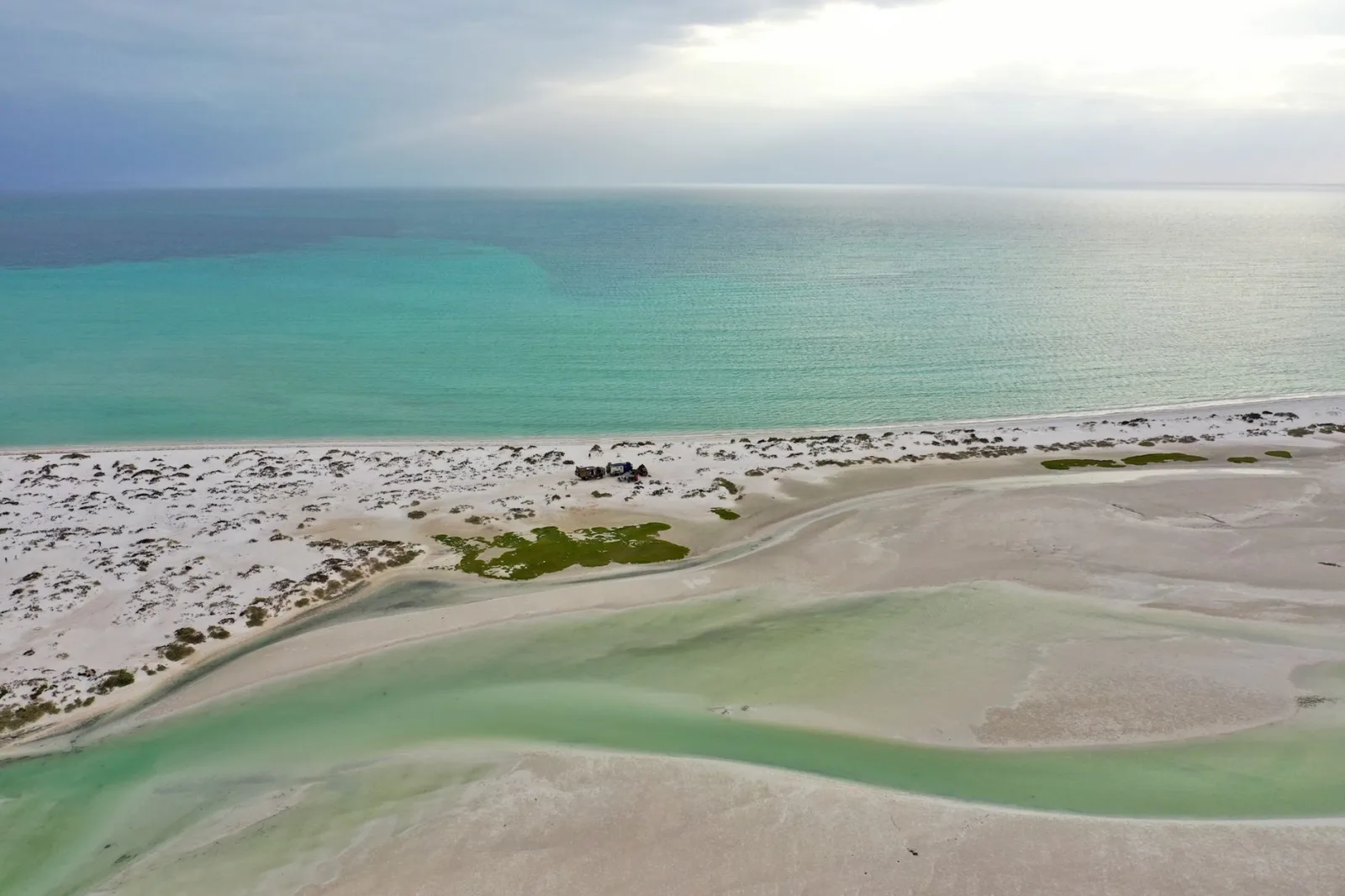 Explore this tranquil and deserted beach in Oman with crystal-clear waters and serene sands.