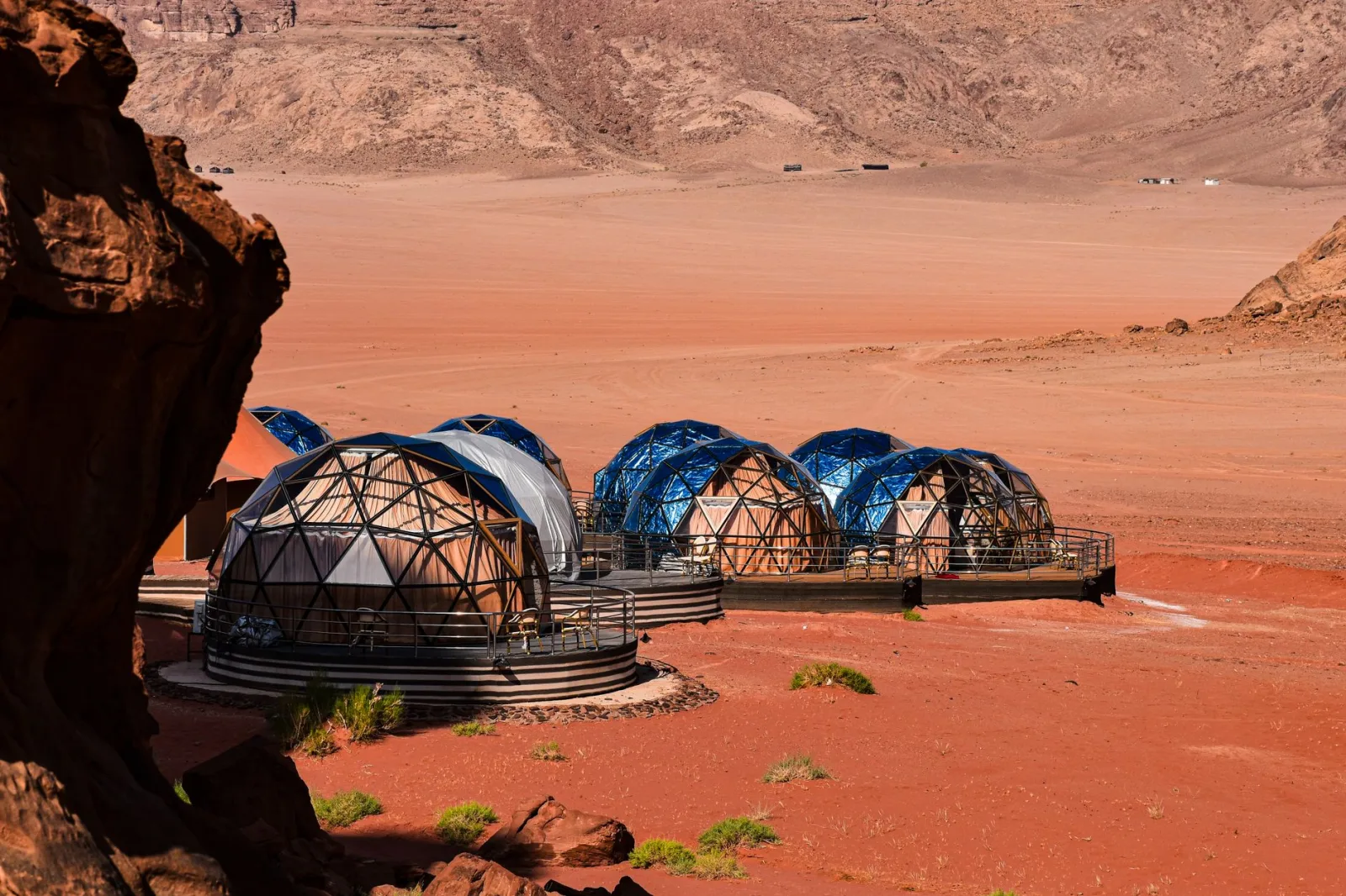 Geodesic domes in the stunning red desert landscape of Wadi Rum, Jordan, offering a unique travel experience.